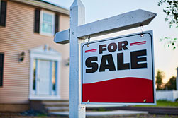 For sale sign in front of home