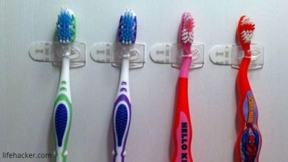 Small Command Hooks to hold toothbrushes in a medicine cabinet