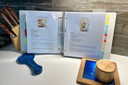 3-ring binder of organized recipes with color tabs and color photos.