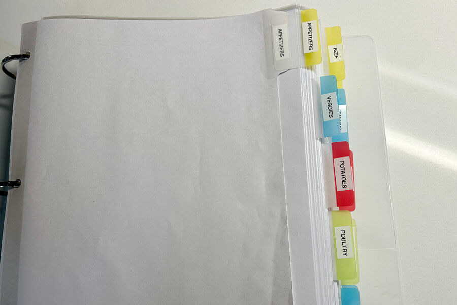 Finished recipe organization project with a 3-ring binder and colorful labeled tabs